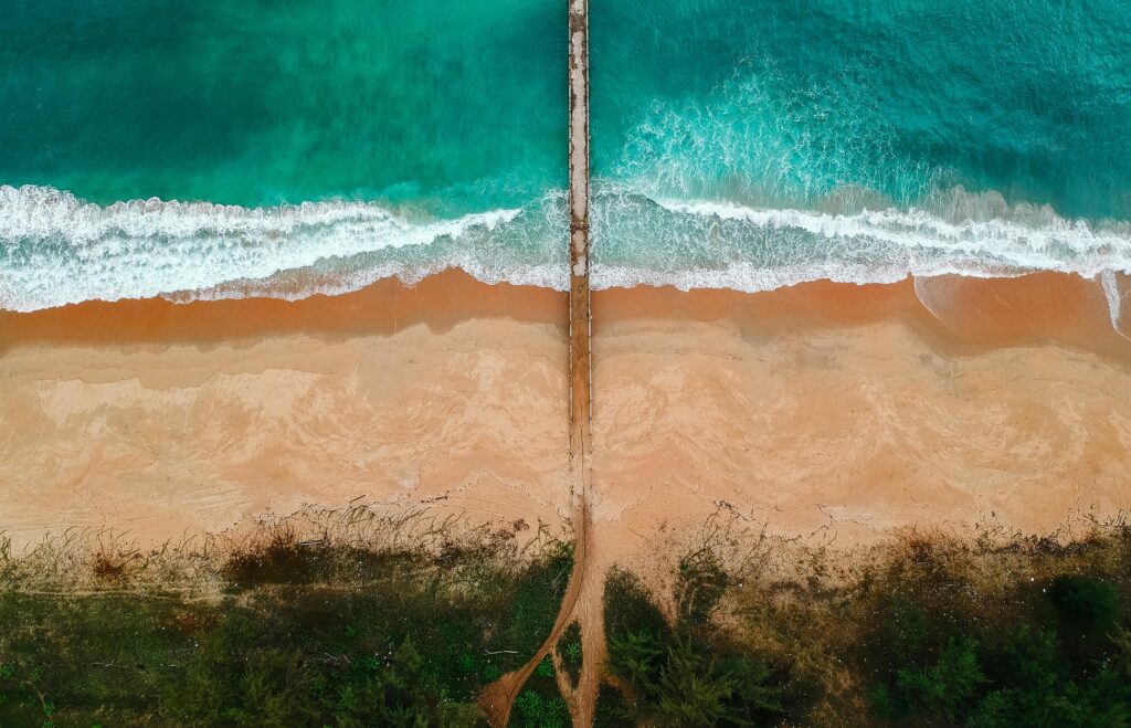 beautiful view of beach sand and water and pathway into the water