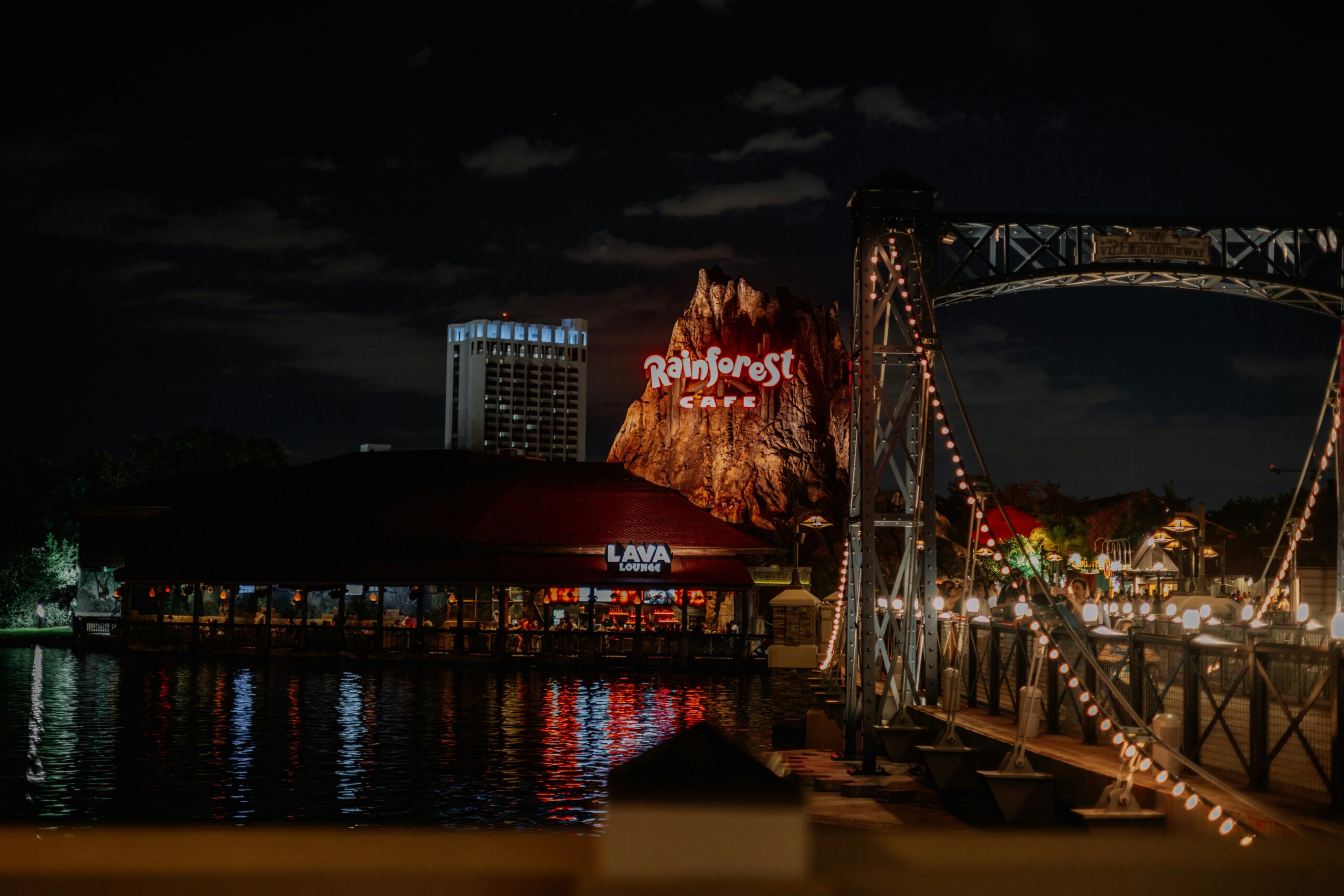 Night time at Disney Springs on the water overlooking the Rainforest Cafe