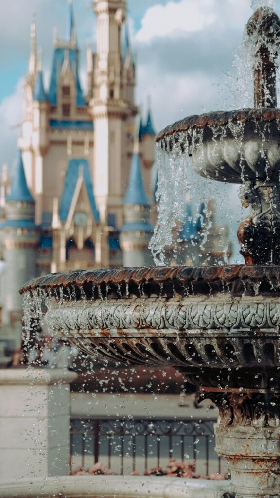 a fountain in front of Cinderella's castle at Magic Kingdom