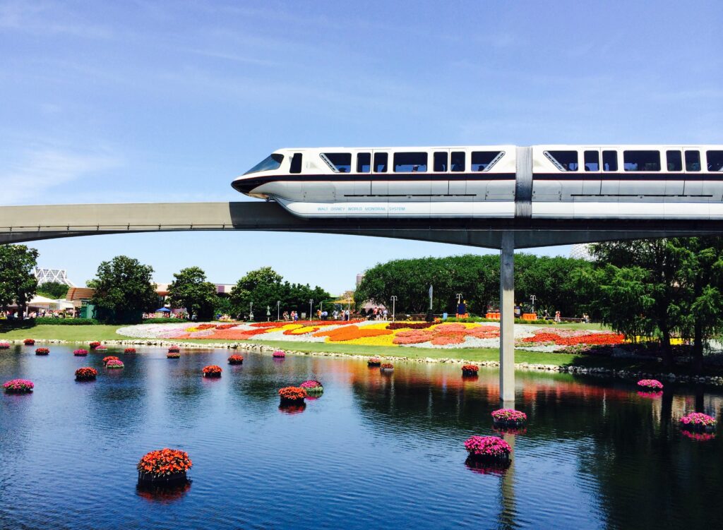 Monorail above water and flowers picture for free Disney World vacation guide