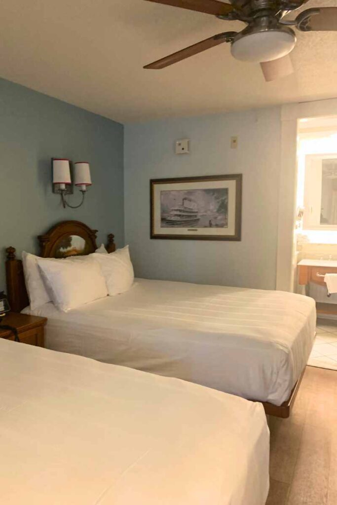 Port Orleans Riverside hotel room queen beds and steamboat painting