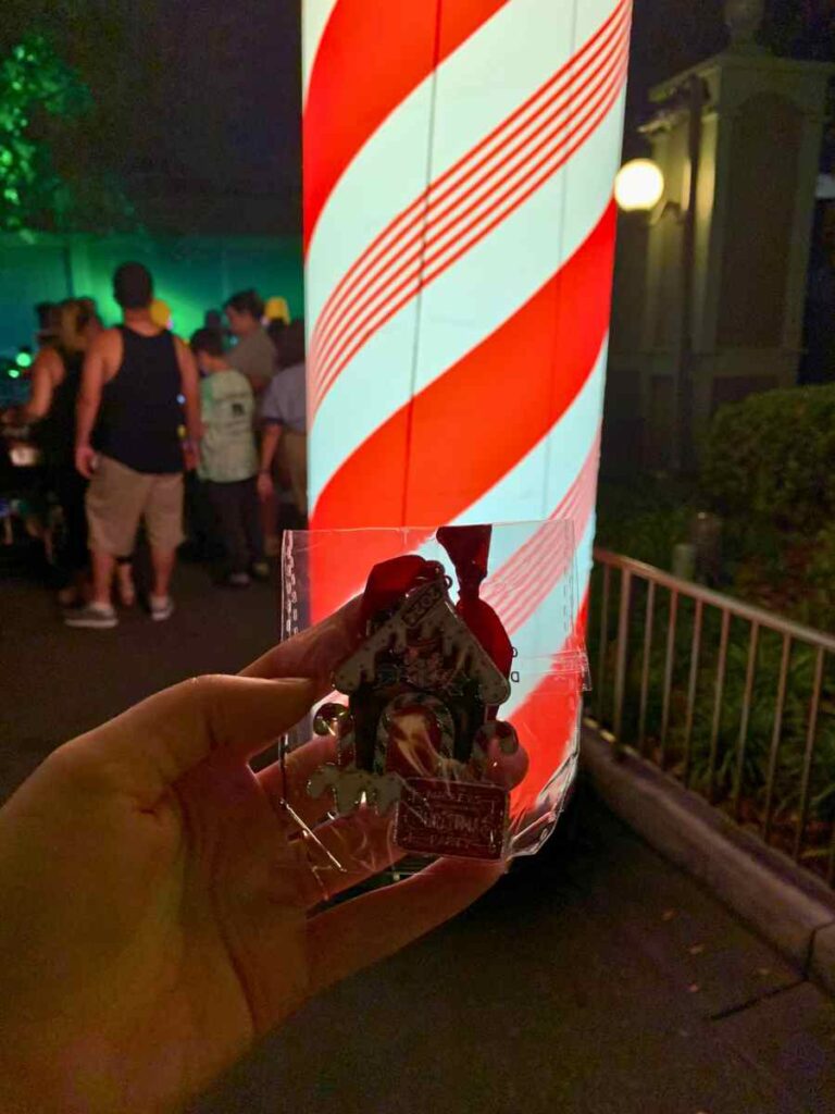The candy cane blow up markers to indicate a special location during Mickey's Christmas Party for complimentary cookies, drinks, and even a gingerbread ornament