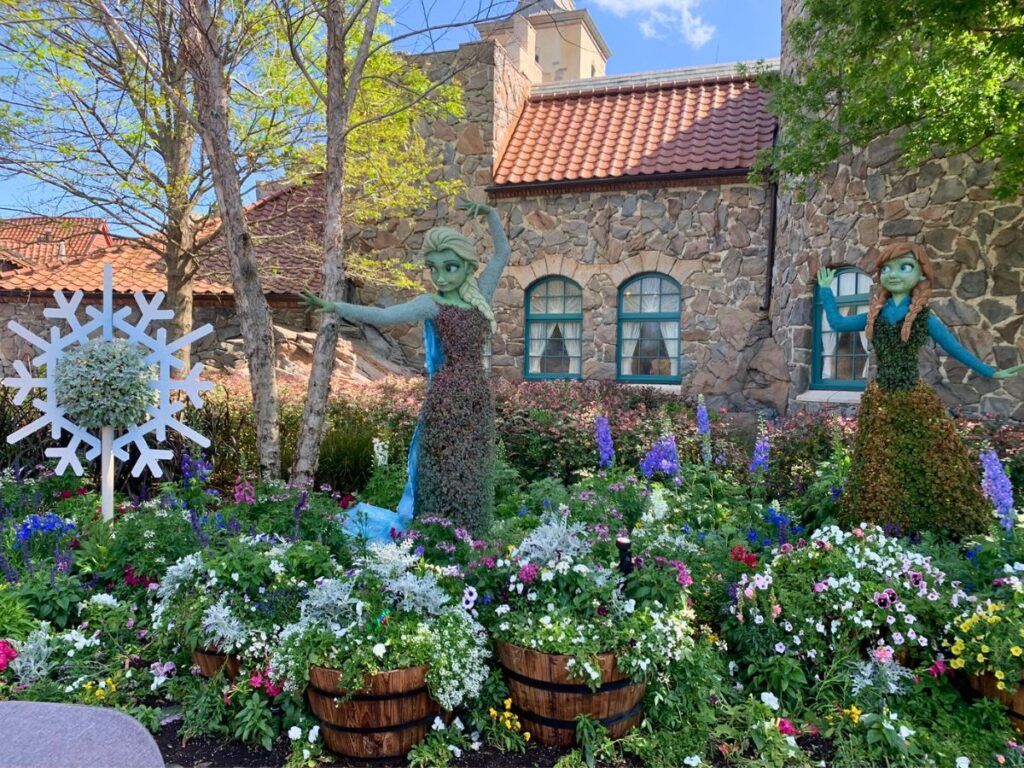 Disney topiaries at the Flower and Garden festival, including Elsa and Anna from the movie Frozen. Also pictured is a snowflake topiary on the left.
